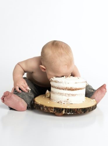 Photo of toddler eating cake